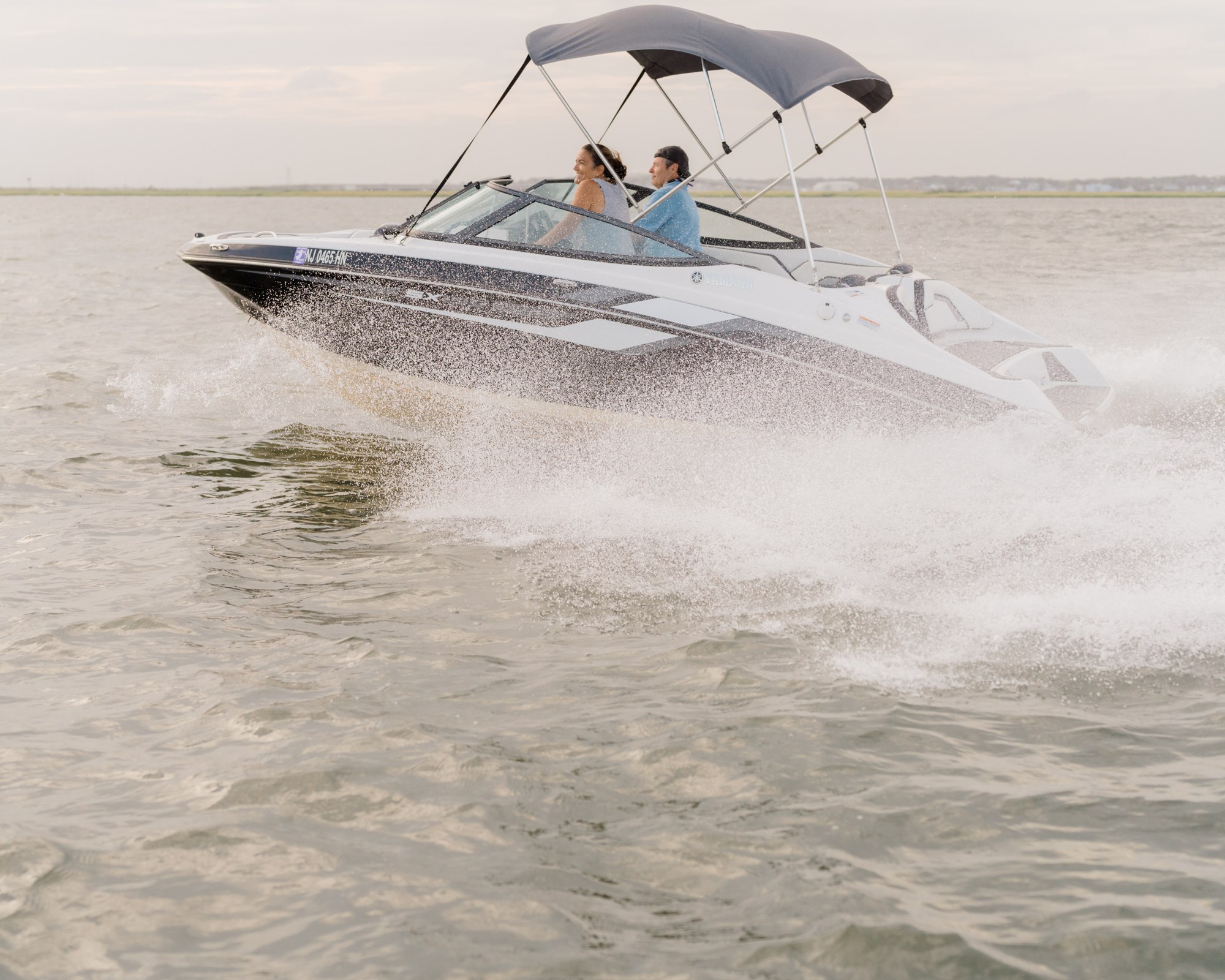 Jet Drive Exchange Yamaha jet boat running across the bay near Ocean City, NJ with marsh shoreline in the background