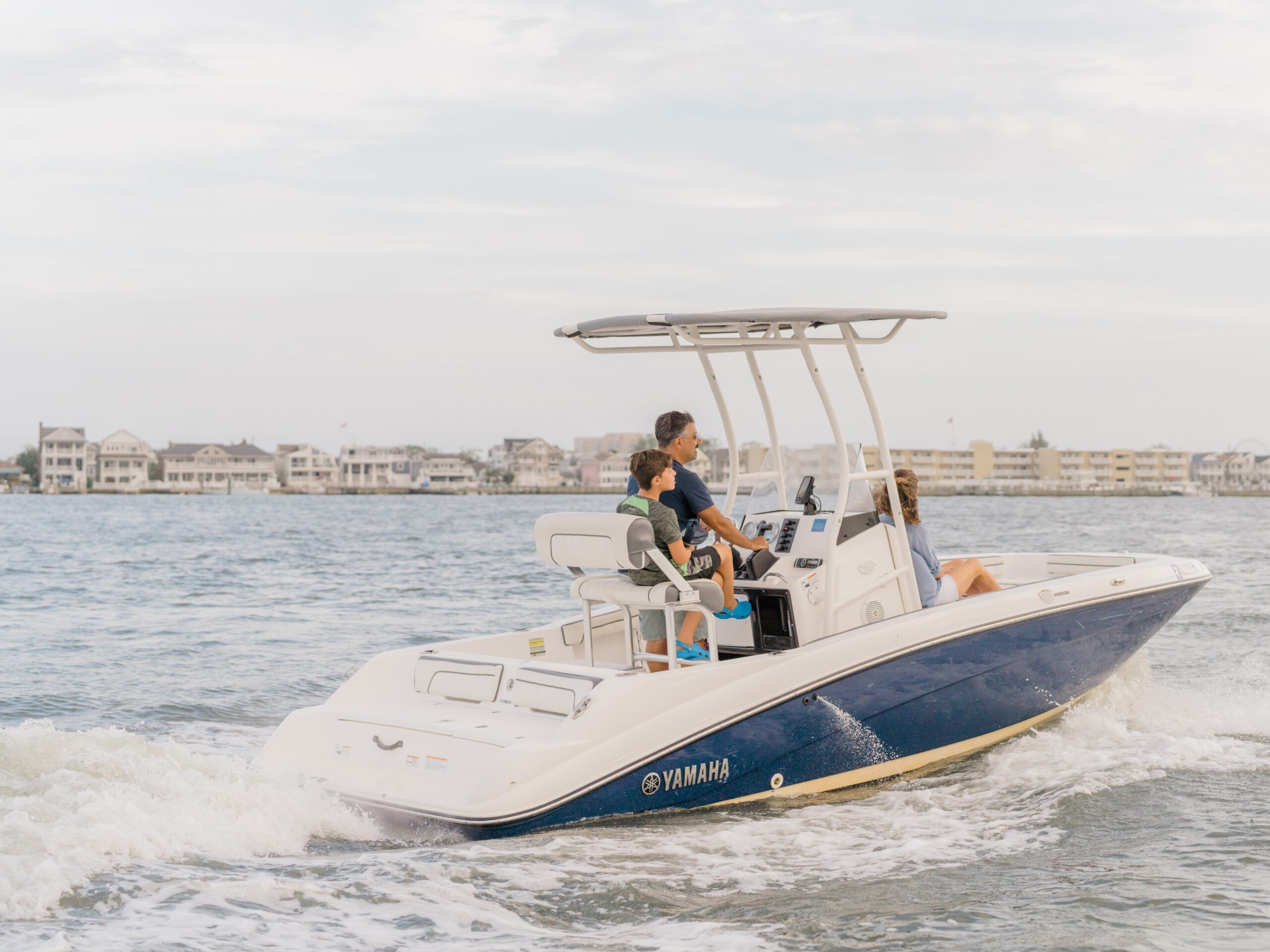 A family cruises the bay near Ocean City, NJ on a Jet Drive Exchange Yamaha center console boat.
